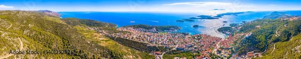 Fototapeta A breathtaking panoramic view of the beautiful landscape of Hvar Town, Croatia, featuring lush Mediterranean surroundings, and the sparkling Pakleni Islands archipelago in the distance