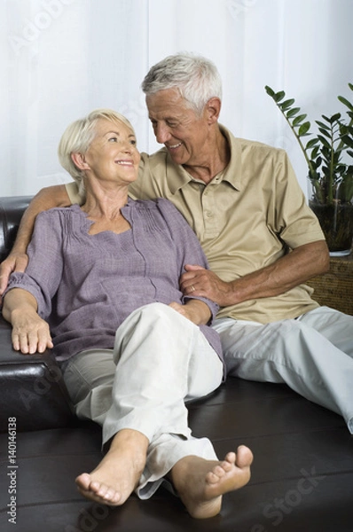 Obraz Senior couple sitting on sofa