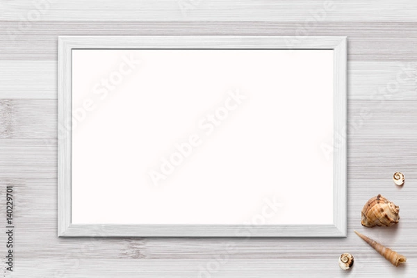 Fototapeta Template of blank poster in wooden frame on rustic wooden background with seashells