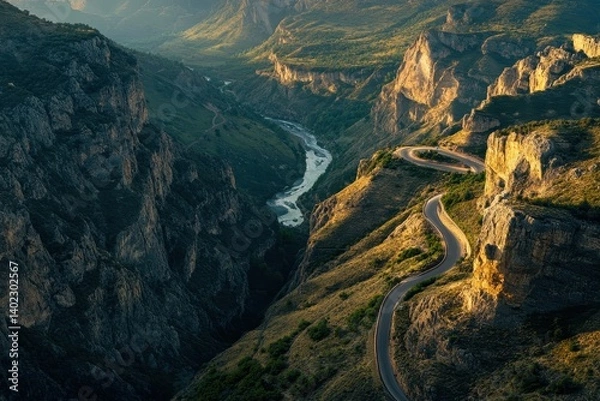 Fototapeta A winding road traverses a scenic mountainous canyon landscape with river