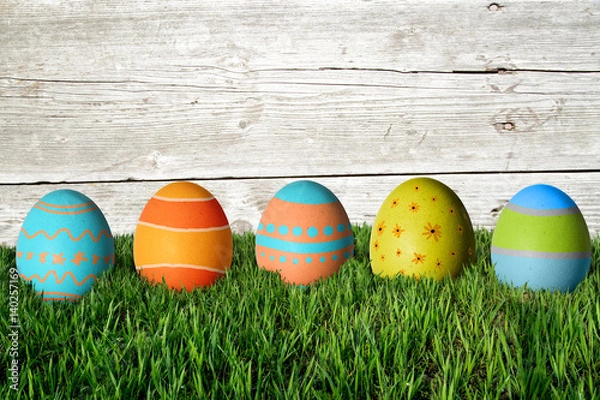 Obraz Easter eggs in green grass. Happy Easter.