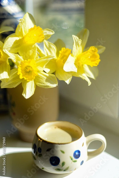 Fototapeta Coffee and daffodils in a beautiful morning moment