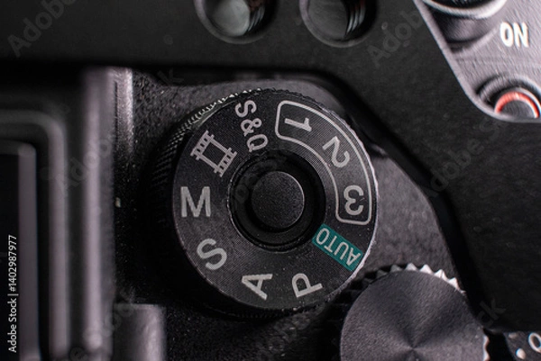 Fototapeta Close-up photo detail of a digital camera mode switch scroll wheel power button 