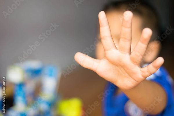 Fototapeta the child reaches out a hand to the camera
