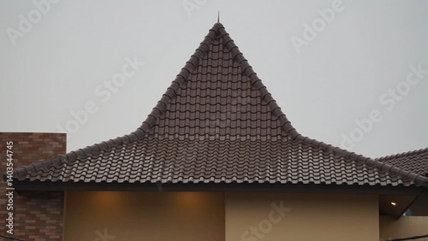 Fototapeta Appearance of a neat roof in a house during the day
