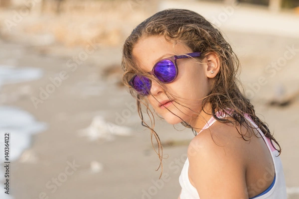 Obraz Little girl bathing on the beach with glasses.