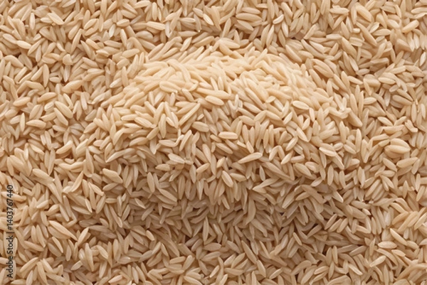 Fototapeta ntegral, uncooked long grain brown rice pile isolated on white background, top view