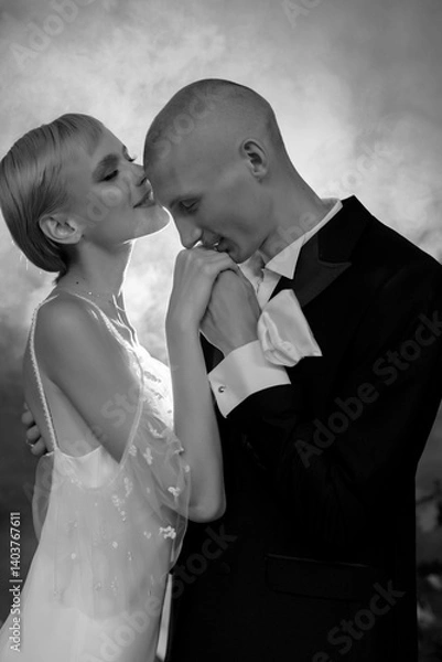 Obraz Attractive young couple in love kissing and hugging in romantic foggy atmosphere