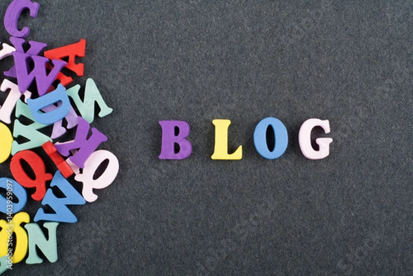 Obraz BLOG word on black board background composed from colorful abc alphabet block wooden letters, copy space for ad text. Learning english concept.