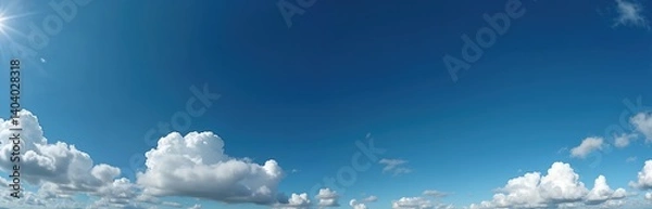 Fototapeta Panoramic photo of a bright blue sky with fluffy white clouds. Seamless panorama for 3D graphics or game development. Beautiful background perfect for sky replacement or drone shots.