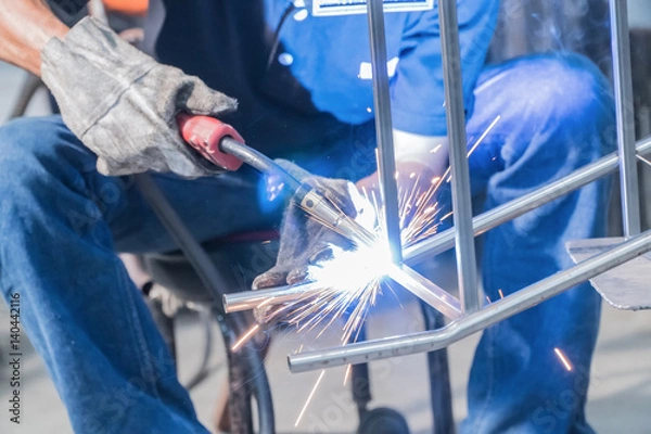 Fototapeta Making sure he's protected while welding