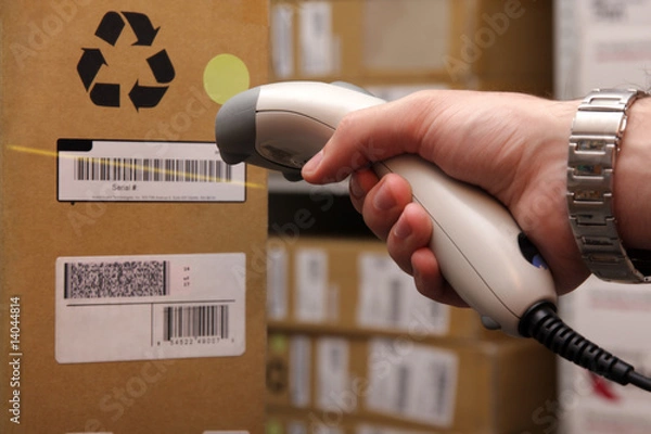 Obraz Man hand with barcode scanner in operation.