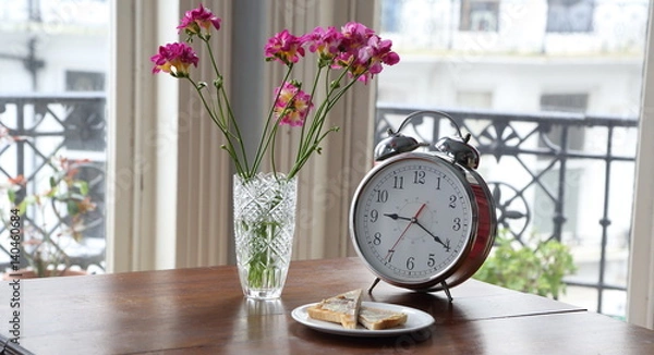Obraz Retro clock with flowers on antique table