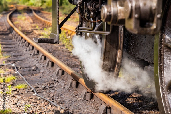 Fototapeta Iconic Jacobite steam train crosses Glenfinnan Viaduct and stops at the station, with historical details, smoke, and nostalgia. Timeless and magical icon in the Scottish Highlands. Locomotive interior