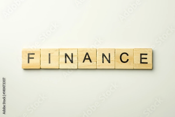 Fototapeta Text wooden blocks spelling the word FINANCE on white background