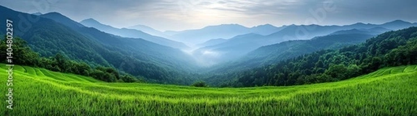 Fototapeta A breathtaking panoramic view of lush green fields stretching towards distant mountains under a serene sky, ideal for conveying tranquility, nature's beauty, and outdoor exploratio