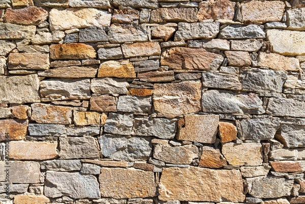 Fototapeta The surface of an stone wall, perfect for the background.