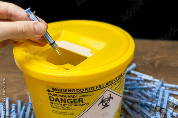 Obraz Needles being put ito a sharps bin