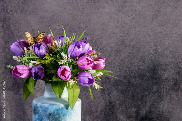 Fototapeta Colorful tulip bouquet with butterfly isolated on grey background with room for copy
