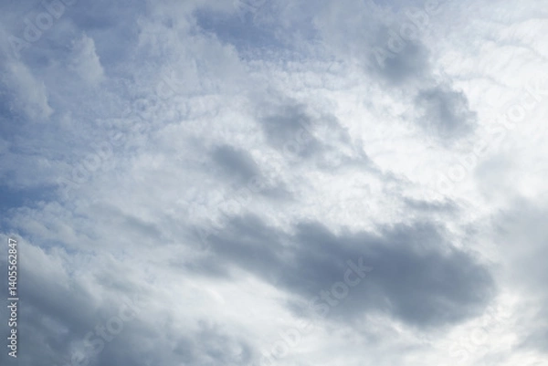 Fototapeta sky of dark, heavy clouds loom overhead, casting a gloomy shadow the air thick with the promise of approaching rain was about to fall casting a moody glow over the early evening dusk sun rise fall
