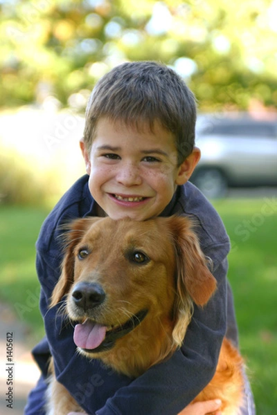 Obraz boy hugging dog