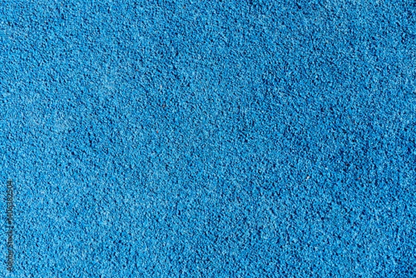 Fototapeta An eye-catching bright blue surface featuring a textured finish, suitable for recreational areas, play zones, or sports facilities, often used in parks or gyms
