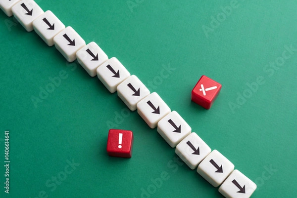 Obraz Representing disruption and deviation, a single file of white dice with black downward arrows is offset by two red dice featuring a white exclamation mark and a cross, all against a solid green backgr