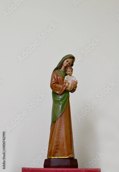 Fototapeta Closeup of Statue of Our lady virgin Mary with Child Jesus located in front of the catholic church with natural background, Thailand. selective focus.