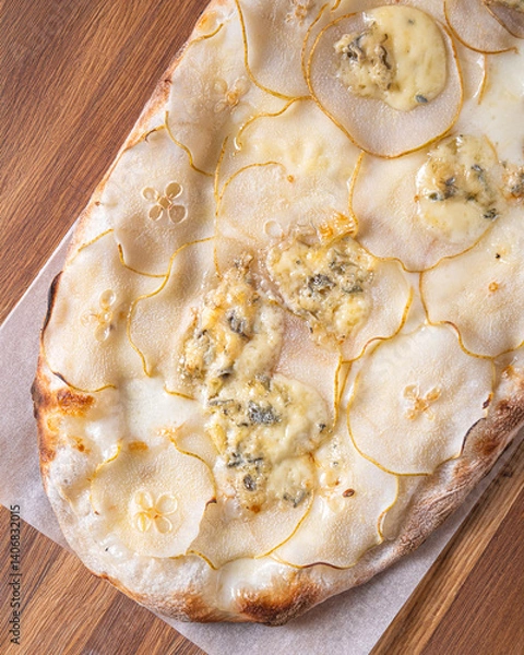 Obraz pizza 4 cheese on a wooden board cooked in a wood stove.Centered composition .Top view.Close-up Macro shot