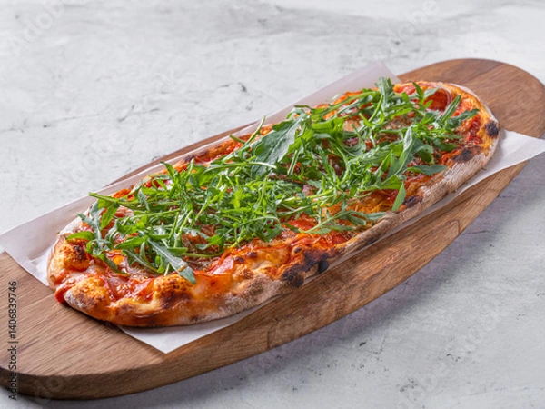 Obraz Classic Margherita pizza with a thin, crispy crust, rich tomato sauce, melted mozzarella, and fresh basil leaves. Served on a rustic wooden board with a warm, textured background, emphasizing its
