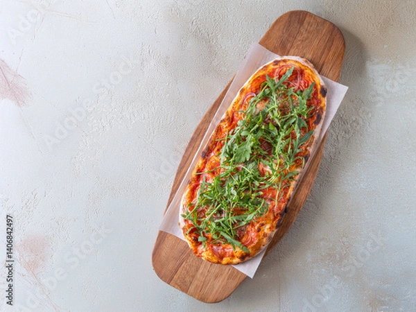 Obraz Classic Margherita pizza with a thin, crispy crust, rich tomato sauce, melted mozzarella, and fresh basil leaves. Served on a rustic wooden board with a warm, textured background, emphasizing its