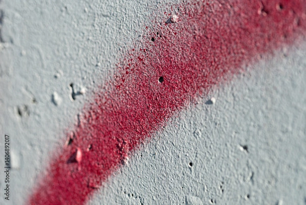 Obraz Closeup macro shot of red graffiti paint on a concrete wall