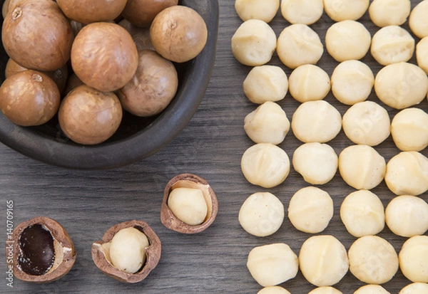 Fototapeta Organic Macadamia nut on wooden table
