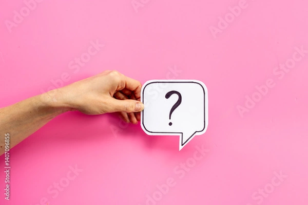 Fototapeta Hands are holding Question mark speech bubbles top view. FAQ concept
