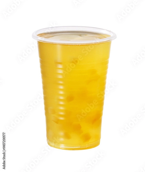 Fototapeta A refreshing drink in a clear glass with fruit cubes suspended in a cloudy but translucent drink creates a visually intriguing texture.