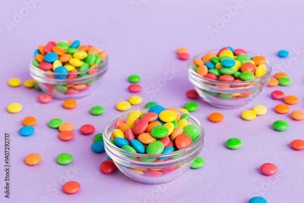 Fototapeta Multicolored candies in a bowl on a colored background. birthday and holiday concept. Top view with copy space