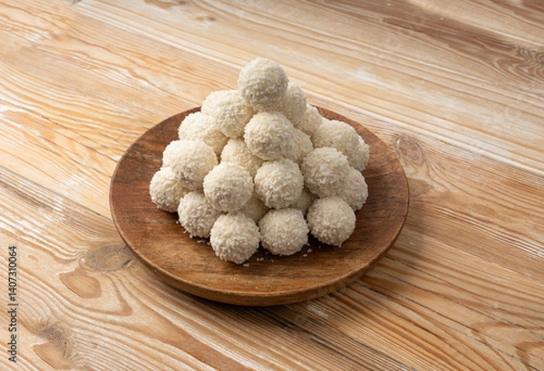 Obraz Coconut candies pile, coco ball. White truffle ball, indian ladoo or laddu with sweet cream and coco