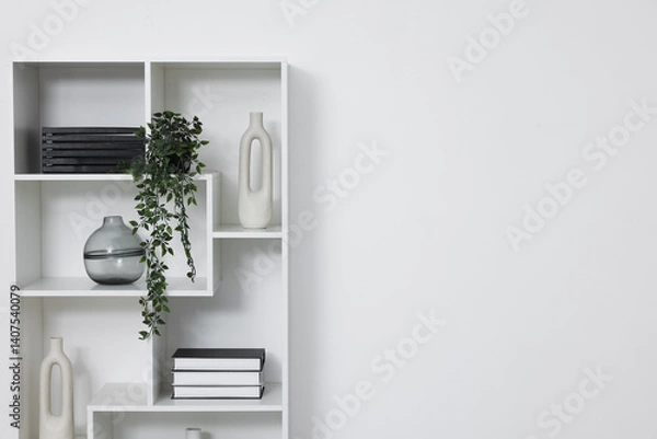 Fototapeta Shelving unit with decor near white wall indoors, space for text