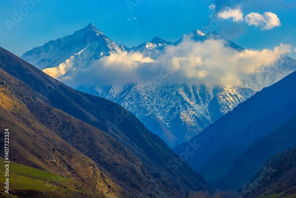 Obraz Majestic mountain valley with snow-capped peaks.