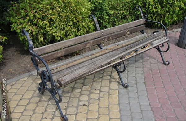 Fototapeta a park bench damaged by hooligans. a broken bench is an example of hooliganism and vandalism