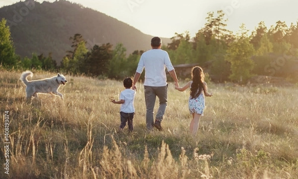 Obraz Dad with kids and dog walks in nature