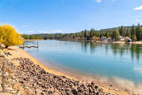 Fototapeta Waterfront homes with sandy beaches, boat slips and docks along the Spokane River at early Spring in the Coeur d'Alene region of North Idaho at Ross Point Recreation site and park.