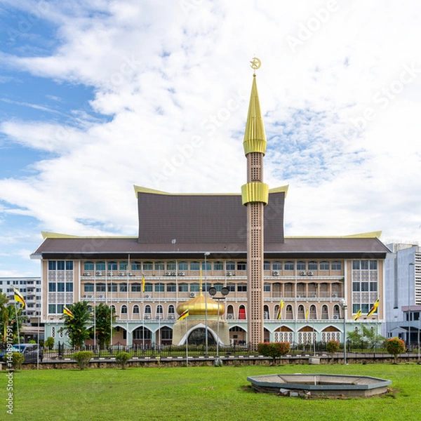 Fototapeta Visitors admire the stunning architecture of the Department of Syariah Affairs building in Bandar Seri Begawan, Brunei, showcasing its golden dome and intricate design under a clear sky