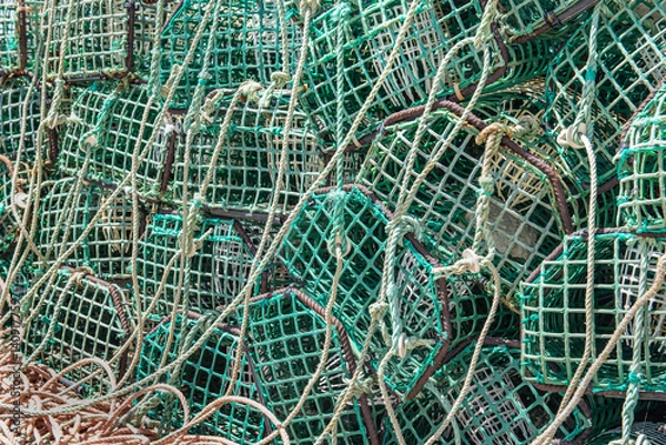 Fototapeta close-up of green mesh fishing traps stacked on a port in Portugal