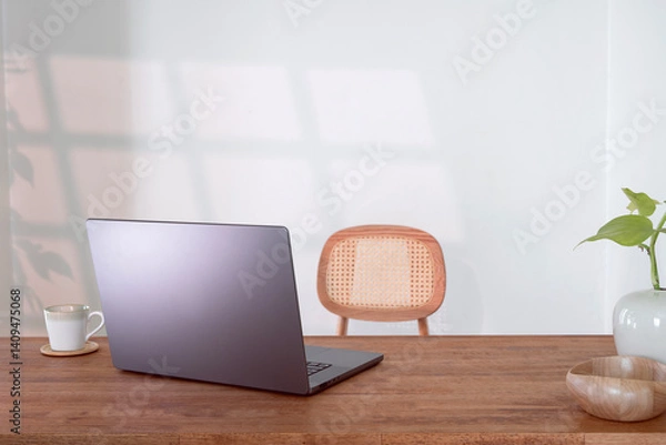 Fototapeta Laptop notebook on wooden table, cozy workspace in living room.