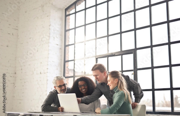 Fototapeta group of people in a modern industrial office working with a computer
