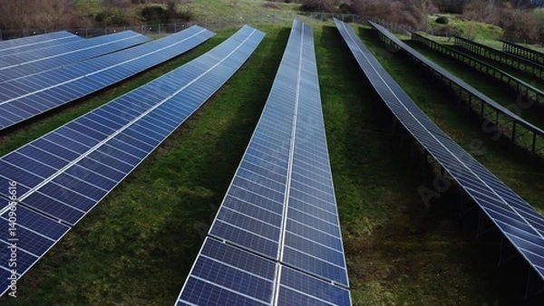 Fototapeta Solar panels installed in the countryside, harnessing renewable energy from the sun. Representing clean energy, sustainability, and the transition to Eco-friendly power solutions.
