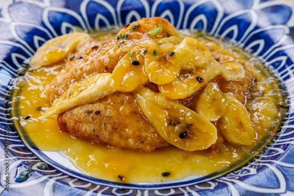Fototapeta Black scabbardfish with banana and Passion fruit syrup in restaurant on Madeira Island in Portugal