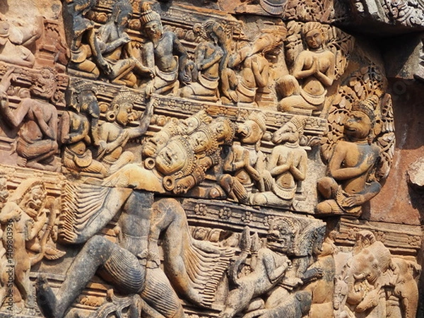 Fototapeta Ancient stone temple with detailed carvings and statues at the entrance
