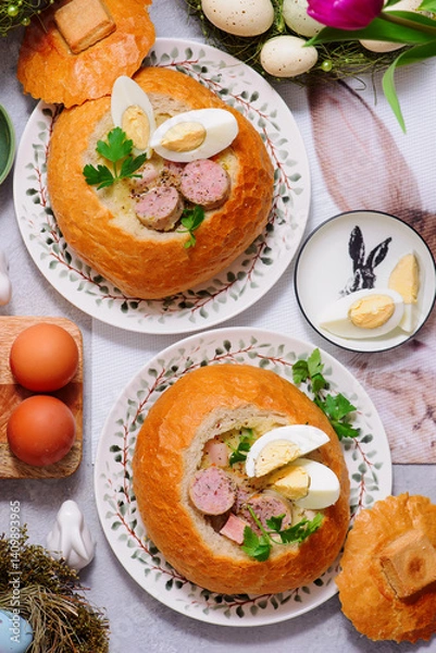 Obraz Traditional Polish Easter soup zurek served in a loaf of bread, smoked meats and egg..top veiw